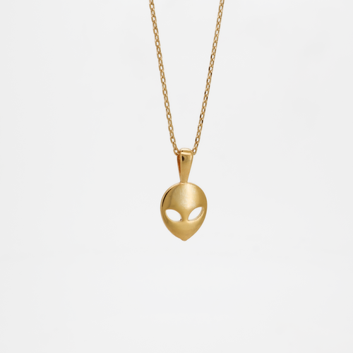 Gold alien head pendant necklace with smooth polished finish, photographed on a white background.