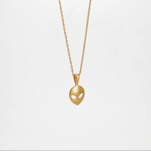 Gold alien head pendant necklace with smooth polished finish, photographed on a white background.