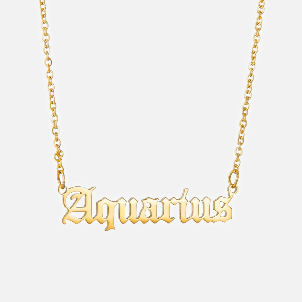 A gold-plated necklace with the word 'Aquarius' written in gothic font on a chain.