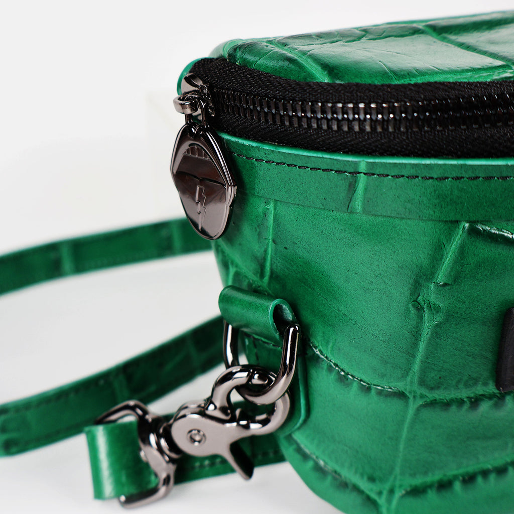 A green crocodile pressed leather side view showing the hardware 