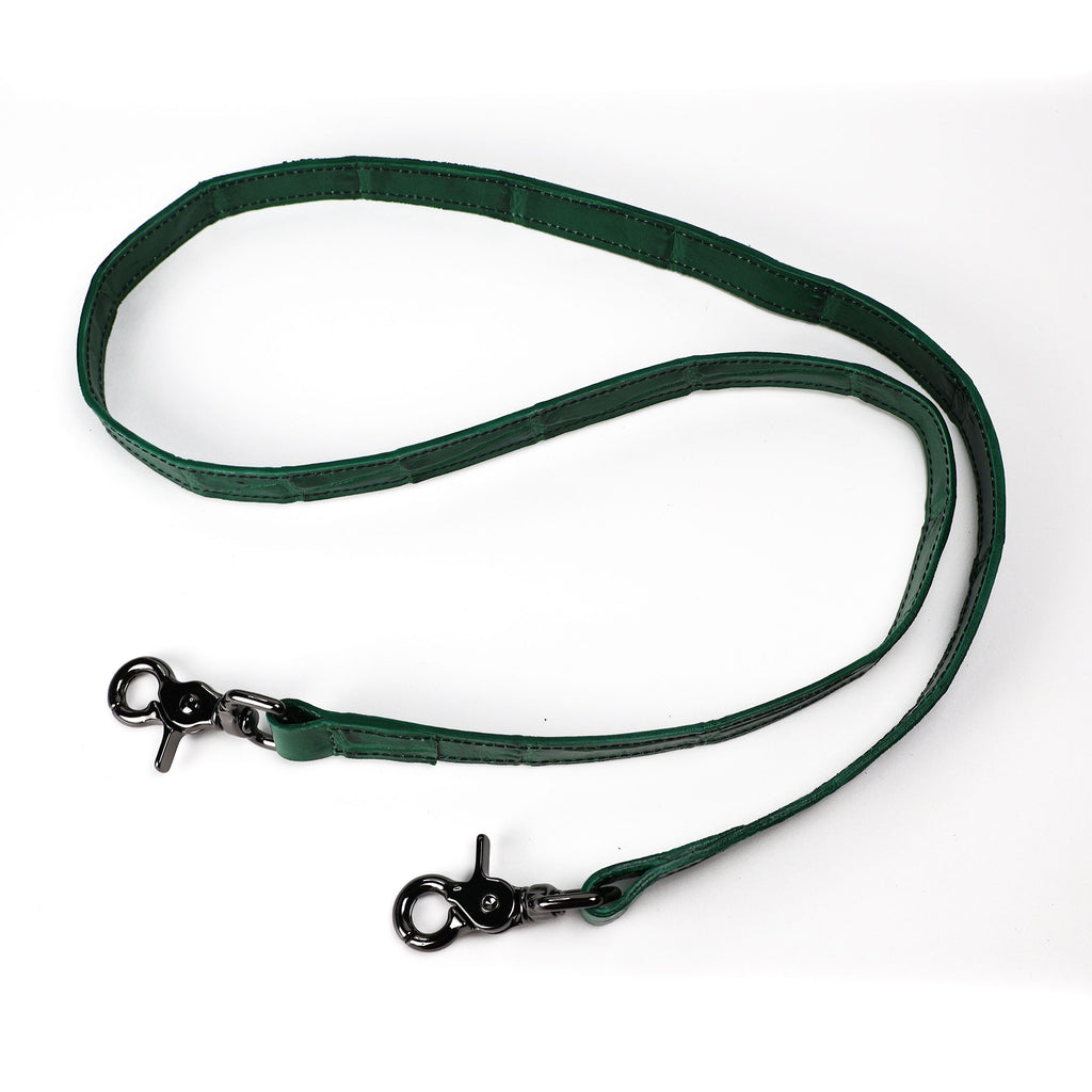 A green crocodile pressed leather strap with gunmetal hardware 