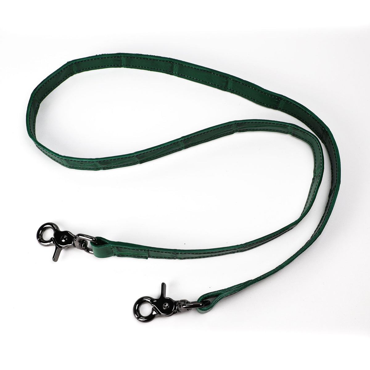 A green crocodile pressed leather strap with gunmetal hardware 