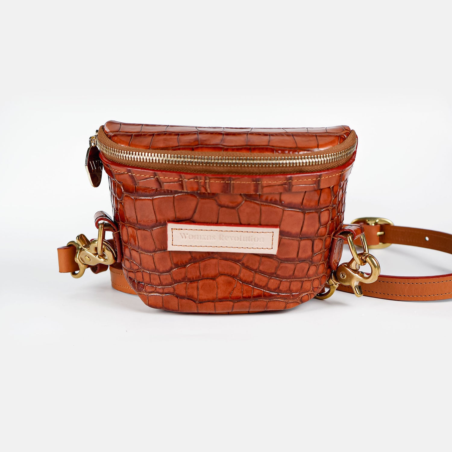 Small brown croc-embossed leather crossbody bum bag with gold zipper and hardware on a white studio background
