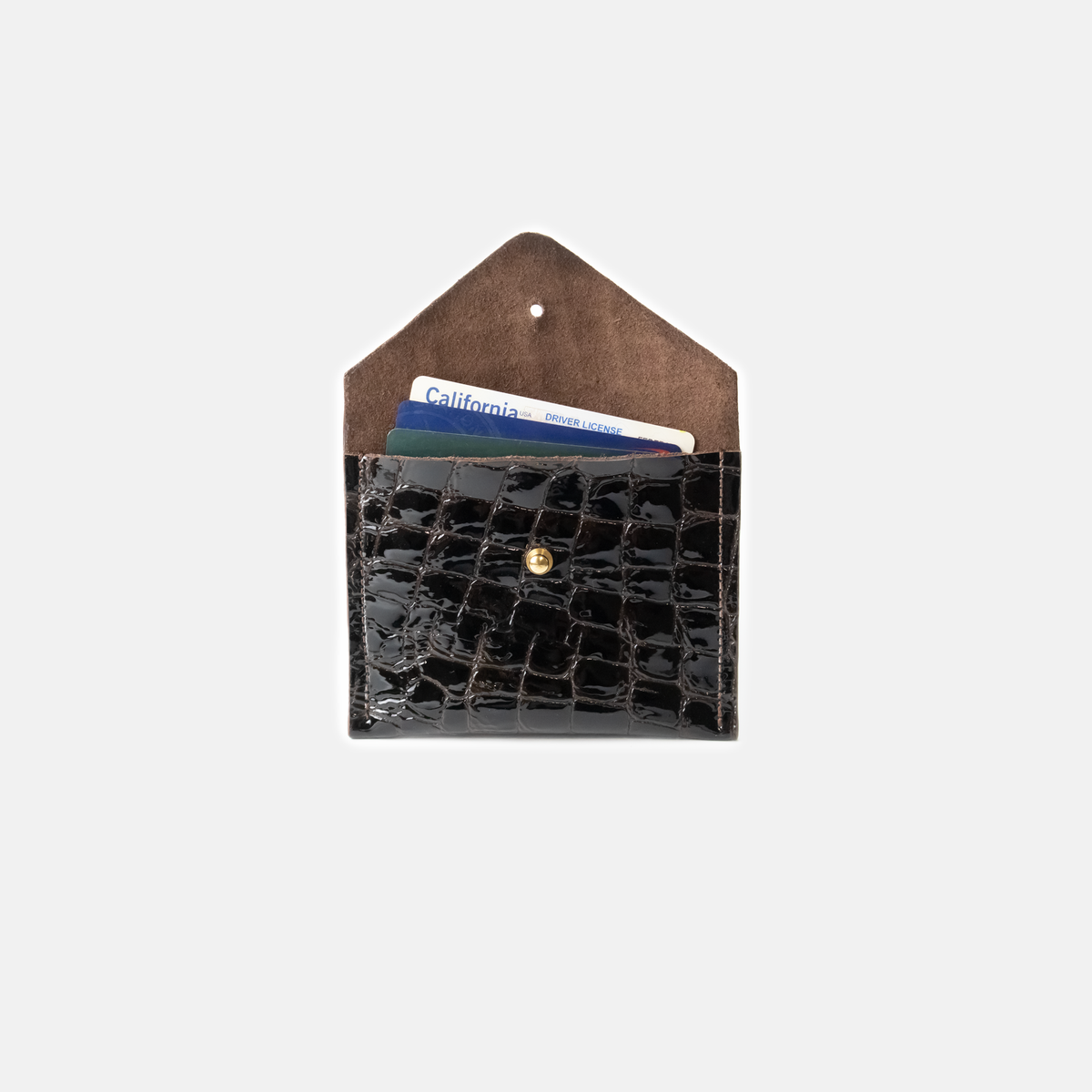 Dark brown crocodile-patterned leather cardholder with a brown flap on a light gray background