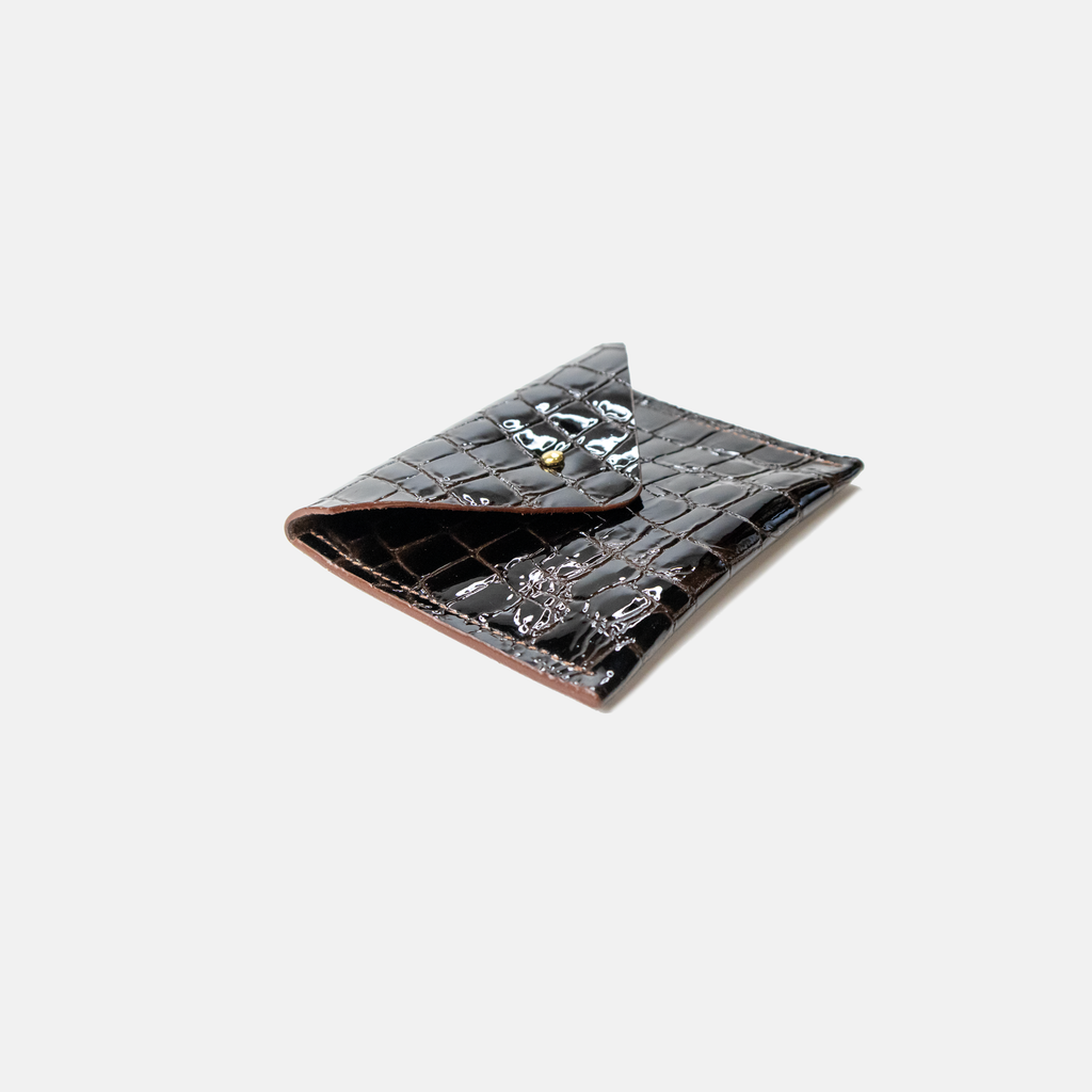 Dark Brown leather crocodile-patterned wallet on a light gray background