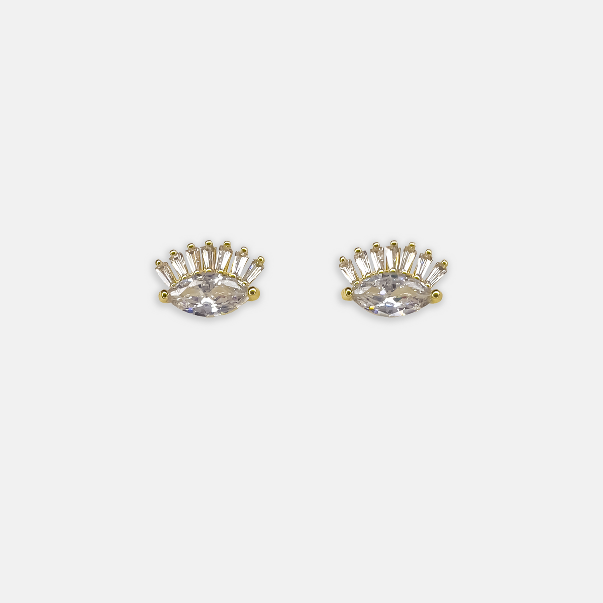Gold eye-shaped stud earrings with clear crystals