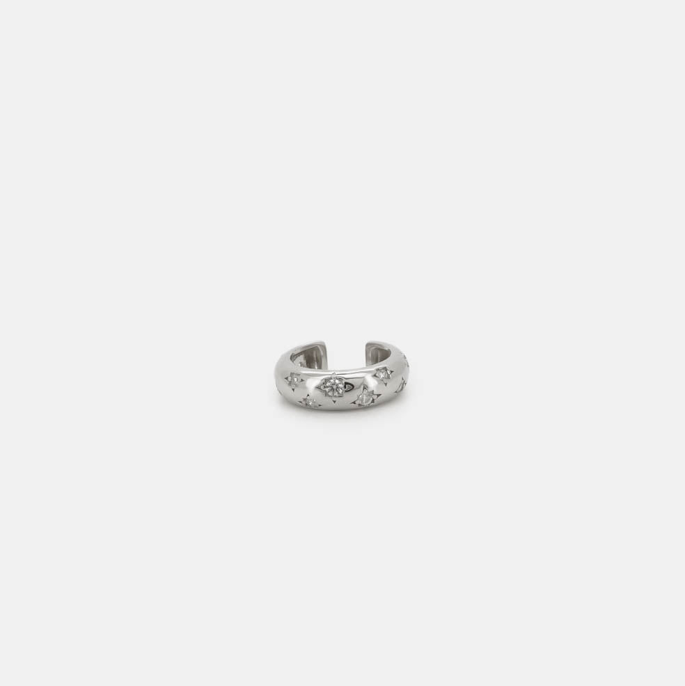 Silver ear cuff with star-shaped crystal details, shown on a white background.