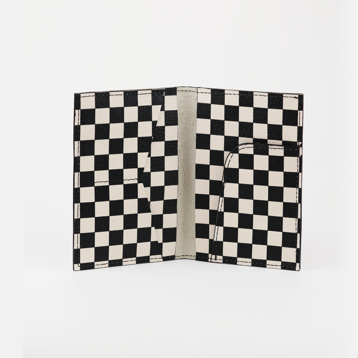 Checkered passport cover open to show the suede lining