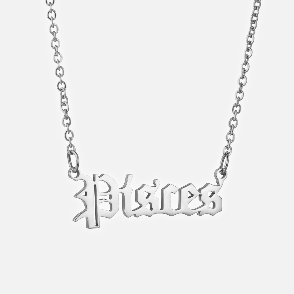 A silver stainless steel necklace with the word 'Pisces' written in a bold, gothic font on a chain with an extender.