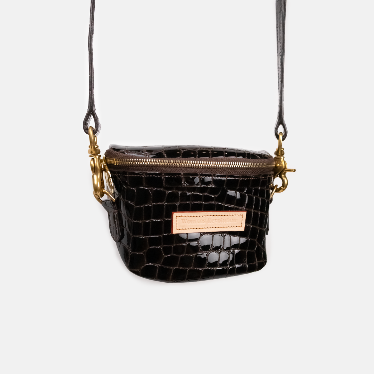 Dark Brown crocodile-patterned handbag with gold accents on a light gray background