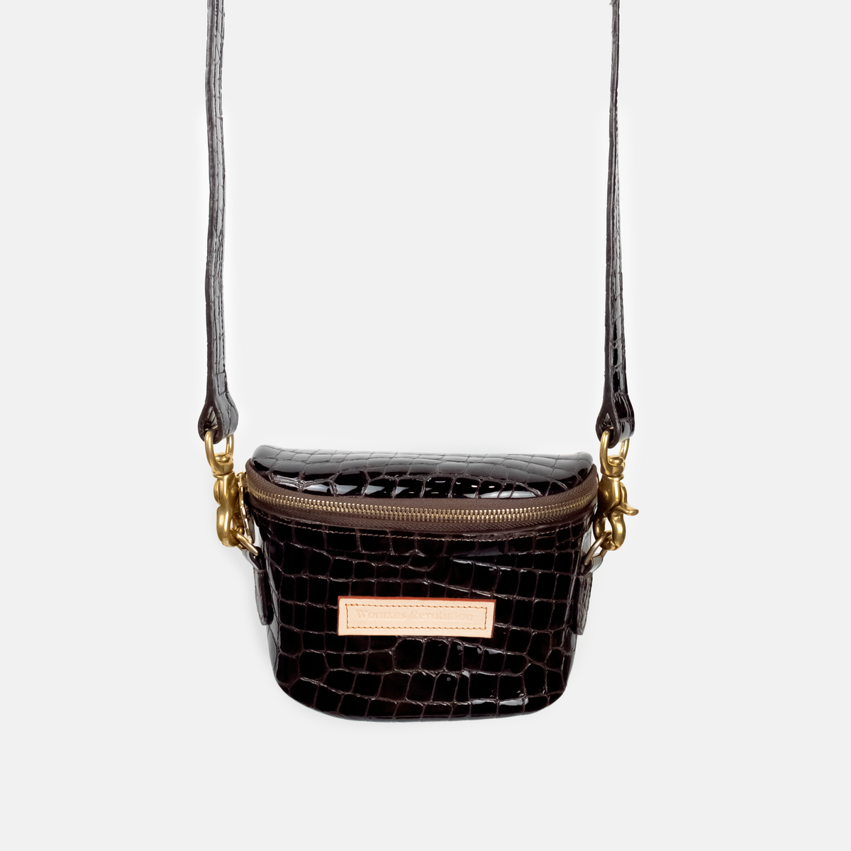 Dark Brown crocodile-patterned handbag with gold accents on a light gray background